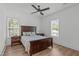 Bright bedroom features a ceiling fan, wood floors, and multiple windows for natural light at 415 1St St, Apex, NC 27502