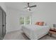 Bright bedroom featuring a ceiling fan, two windows, and neutral carpet at 415 1St St, Apex, NC 27502