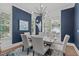 Dining room with dark blue accent wall, modern chandelier, and table set for a dinner party at 415 1St St, Apex, NC 27502