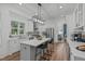 Bright kitchen with white cabinets, stainless steel appliances, granite countertops, and an island at 415 1St St, Apex, NC 27502
