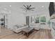 Bright living area with comfortable seating, lots of light, and contemporary ceiling fan at 415 1St St, Apex, NC 27502