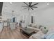 Open concept living room adjacent to the kitchen, featuring modern decor, an inviting sofa and a large island at 415 1St St, Apex, NC 27502