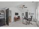 Spacious home office featuring modern desk and chair, TV, and updated ceiling fan at 415 1St St, Apex, NC 27502