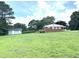 Expansive backyard with the house and shed on a sunny day at 4796 Covered Bridge Rd, Archer Lodge, NC 27527