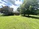View of brick home with lush, sprawling backyard surrounded by mature trees at 4796 Covered Bridge Rd, Archer Lodge, NC 27527