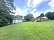 Spacious backyard with shed and a view of the home's back exterior at 4796 Covered Bridge Rd, Archer Lodge, NC 27527