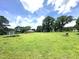 Large, green backyard features a view of the house and shed at 4796 Covered Bridge Rd, Archer Lodge, NC 27527