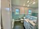 Bathroom featuring blue tile accents, a vanity with storage, and a clean design at 4796 Covered Bridge Rd, Archer Lodge, NC 27527