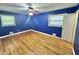 Bedroom boasts hardwood floors, a ceiling fan, and dual windows for natural light at 4796 Covered Bridge Rd, Archer Lodge, NC 27527