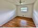 Cozy bedroom with hardwood floors, natural light, and neutral wall color at 4796 Covered Bridge Rd, Archer Lodge, NC 27527