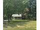 Cozy brick home surrounded by mature trees, providing shade and privacy at 4796 Covered Bridge Rd, Archer Lodge, NC 27527