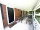 Covered front porch featuring seating, brick exterior, and a 'Welcome' mat at 4796 Covered Bridge Rd, Archer Lodge, NC 27527