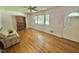 Bright living room showcasing hardwood floors, large windows, and a comfortable couch at 4796 Covered Bridge Rd, Archer Lodge, NC 27527