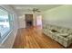 Spacious living room featuring hardwood floors, brick fireplace, and comfortable seating at 4796 Covered Bridge Rd, Archer Lodge, NC 27527