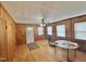 Bright living room with hardwood floors, wood paneled walls, and natural light at 4796 Covered Bridge Rd, Archer Lodge, NC 27527