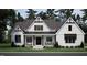 Charming craftsman-style home showcasing a symmetrical façade, covered porch, and manicured lawn at 50 Heritage Trail, Zebulon, NC 27597