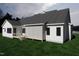 Rear view of a charming home featuring a screened porch and backyard access at 50 Heritage Trail, Zebulon, NC 27597