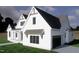 View of the house showing the side entry garage, white siding, and complementing dark roof at 50 Heritage Trail, Zebulon, NC 27597