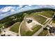 Aerial view of a new construction home on a large lot, showcasing surrounding greenery and pond at 5008 Hopkins Chapel Rd, Zebulon, NC 27597