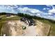 Aerial view of a new construction home, showing the lot, neighboring land, and bright blue skies at 5008 Hopkins Chapel Rd, Zebulon, NC 27597