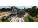 A newly constructed home featuring light gray siding, gray roof, and dark trim windows at 5009 Hopkins Chapel Rd, Zebulon, NC 27597