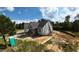 New construction featuring gray siding, a gray shingle roof, and a covered front porch at 5009 Hopkins Chapel Rd, Zebulon, NC 27597