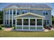 Rear exterior of home featuring a sunroom and patio at 604 Nottely Pl, Cary, NC 27519