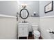 Charming powder room with wainscoting, marble countertop, and stylish fixtures at 604 Nottely Pl, Cary, NC 27519