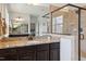 Bathroom with tile shower, double sink vanity with granite countertop, and modern fixtures at 604 Nottely Pl, Cary, NC 27519