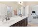 Bathroom featuring double sinks with dark wood cabinetry and a view into the other rooms at 604 Nottely Pl, Cary, NC 27519