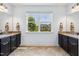 Bathroom with dual vanities, tile floor and a window providing natural light and neighborhood views at 604 Nottely Pl, Cary, NC 27519