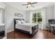 Comfortable bedroom with hardwood floors, natural light, and a view of the outdoors at 604 Nottely Pl, Cary, NC 27519