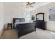 Bedroom with a dark wood bed, dresser, and nightstand, complemented by natural light from two windows at 604 Nottely Pl, Cary, NC 27519