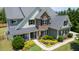 Exterior elevation highlighting a home's stone and siding facade, landscaped front yard, and covered entrance at 604 Nottely Pl, Cary, NC 27519
