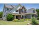 Charming home with a stone facade, well-manicured lawn and beautiful landscaping at 604 Nottely Pl, Cary, NC 27519