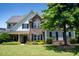 Front of home with a stone facade and manicured lawn at 604 Nottely Pl, Cary, NC 27519
