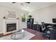 Well-lit office space featuring a fireplace, modern desk, and ample storage at 604 Nottely Pl, Cary, NC 27519