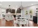 Open kitchen and dining area with modern appliances, granite countertops, and a view of the backyard at 604 Nottely Pl, Cary, NC 27519