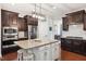 Modern kitchen featuring granite countertops, stainless steel appliances, and custom cabinetry at 604 Nottely Pl, Cary, NC 27519
