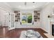 Bright living room featuring custom built-ins and a cozy window seat with backyard views at 604 Nottely Pl, Cary, NC 27519