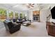 Inviting living room with stone fireplace, coffered ceiling, and plenty of natural light at 604 Nottely Pl, Cary, NC 27519