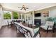 Cozy sunroom with tile floors, fireplace, casual seating, and a mounted television at 604 Nottely Pl, Cary, NC 27519