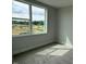 Bedroom featuring neutral carpeting and a large window with a view of trees at 64 Rainfall Dr, Pittsboro, NC 27312