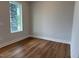 Bright bedroom featuring hardwood floors and a window at 64 Rainfall Dr, Pittsboro, NC 27312
