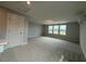 Spacious bonus room featuring plush carpeting and plentiful natural light from large windows at 64 Rainfall Dr, Pittsboro, NC 27312