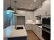 This modern kitchen features white cabinets, stainless steel appliances, and a quartz countertop island at 64 Rainfall Dr, Pittsboro, NC 27312