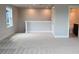 Spacious loft area with neutral carpet, natural light, and an access door to a bathroom at 64 Rainfall Dr, Pittsboro, NC 27312