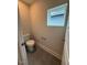 Cozy powder room with modern fixtures and a window for natural light at 64 Rainfall Dr, Pittsboro, NC 27312