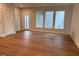 Open concept room with wood floors and three windows for lots of natural light at 64 Rainfall Dr, Pittsboro, NC 27312
