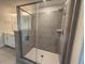 Modern shower with gray tiling, a glass door, and sleek fixtures at 64 Rainfall Dr, Pittsboro, NC 27312